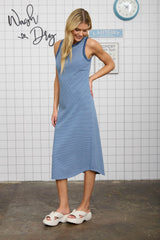 woman wearing a blue and white striped sleeveless midi dress with an asymmetrical hem and casual slide sandals