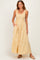 woman wearing a yellow and white gingham sleeveless maxi dress with smocked detailing and side pockets