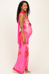 woman wearing a pink floral maternity dress with a open back and a visible baby bump
