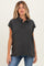 woman wearing a charcoal grey maternity polo shirt with a buttoned placket and rolled sleeves