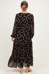 woman wearing a black floral long sleeve maternity maxi dress, seen from the back
