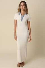 woman wearing a cream-colored maxi dress with a denim collar and short sleeves