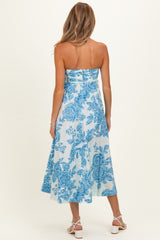 woman wearing a strapless light blue floral maternity dress with a midi length and flowing skirt