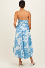 woman wearing a strapless blue floral midi dress with a fitted bodice and flowy skirt, shown from the back