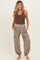 woman wearing a brown ribbed tank top and gray maternity joggers with pockets
