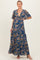 woman wearing a floral print maternity maxi dress with a deep v-neck and short sleeves, showcasing her baby bump