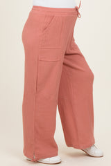 maternity wear in soft pink wide leg pants with pockets and drawstring waist, styled on a model