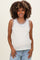 woman wearing a white sleeveless crochet maternity top with colorful trim and displaying her baby bump