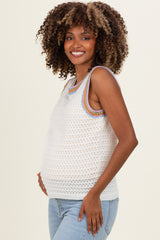woman wearing a light gray crochet maternity tank top with colorful trim and a visible baby bump