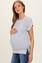 woman wearing a light gray maternity knit top with short sleeves and a visible baby bump