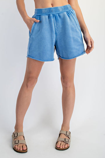 woman wearing light blue casual shorts with side pockets and an elastic waistband