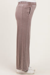 woman wearing soft mauve maternity lounge pants with side pockets and an elastic waistband, baby bump visible