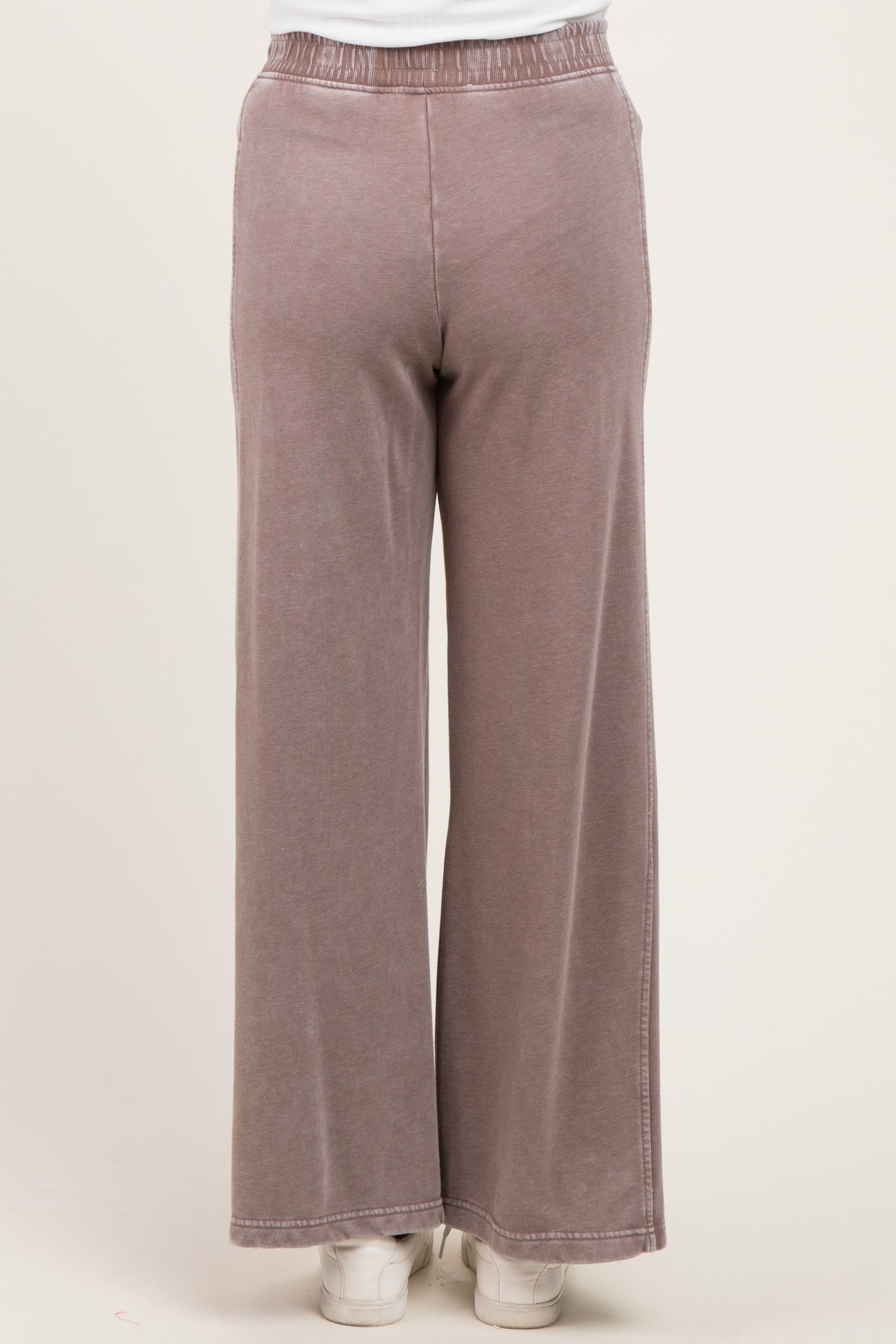 woman wearing mauve maternity wide-leg pants with an elastic waistband, viewed from the back