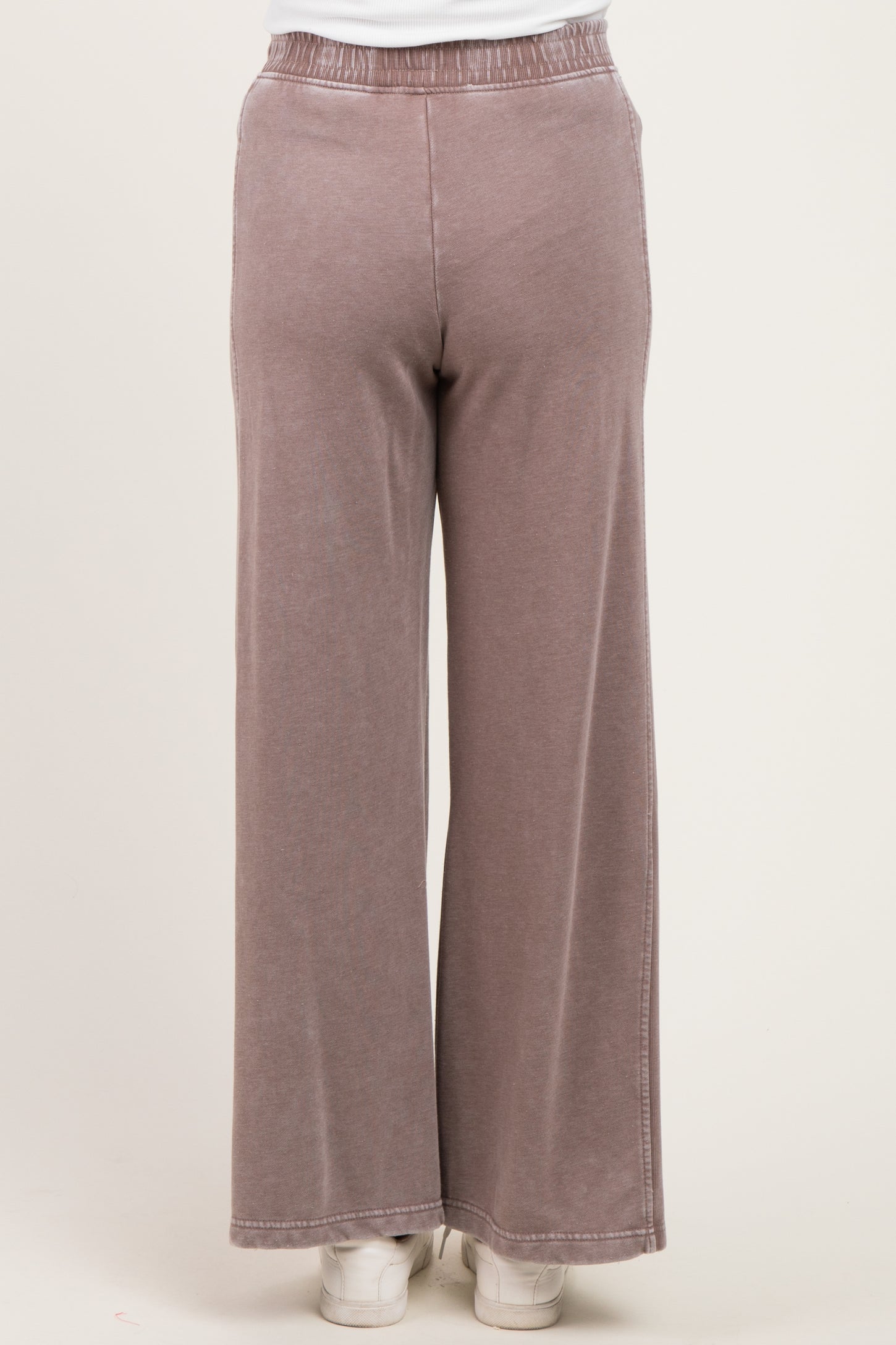 woman wearing mauve maternity wide-leg pants with an elastic waistband, viewed from the back