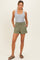 woman wearing a gray tank top and olive green shorts with buttons and side pockets