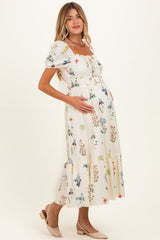 woman wearing a floral print maternity dress with puff sleeves and a ruffled hem, holding her baby bump