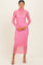 woman wearing a pink sheer polka dot long sleeve midi dress with a turtleneck and fitted silhouette