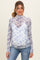 woman wearing a floral print maternity top with a sheer layer over a v-neck underneath and showing her baby bump
