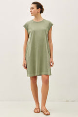 woman wearing a relaxed fit olive green cap sleeve dress with a round neckline and side pockets