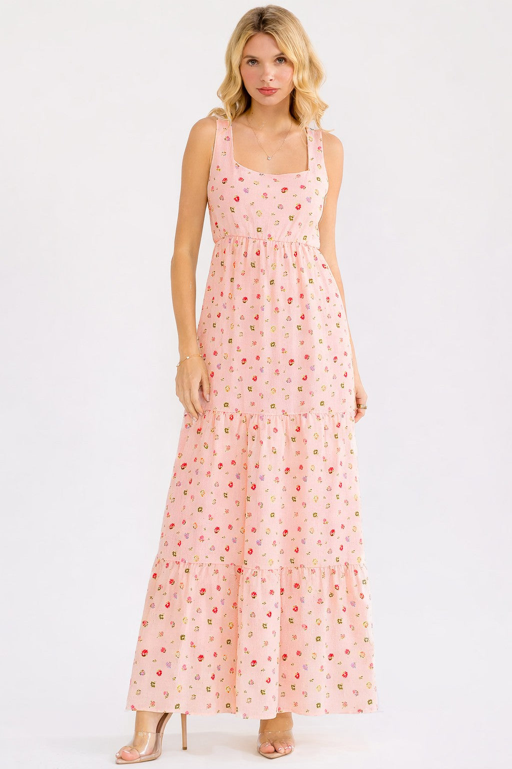 woman wearing a pink floral maxi dress with a square neckline and tiered skirt