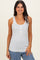 woman wearing a white sleeveless tank top with small blue floral print and buttons on the front