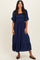 woman wearing a navy blue tiered maxi dress with puff sleeves and a smocked bodice