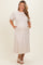 woman wearing a light beige maternity plus midi dress with puff sleeves and pockets, showcasing her baby bump