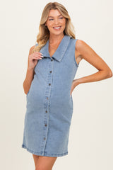 woman wearing a light blue denim maternity dress with a collar and button-down front, showing a baby bump