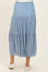 maternity wear flowy blue floral tiered maxi skirt with an elastic waistband, model facing away