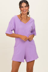 woman wearing a lavender short-sleeve v-neck romper with front pockets