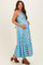 woman wearing a blue striped maternity dress with a ruffled hem and holding her baby bump