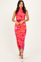 woman wearing a vibrant pink floral midi dress with a fitted silhouette and high neckline