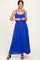 woman wearing a vibrant blue maxi dress with ruffled straps and a tie waist detail
