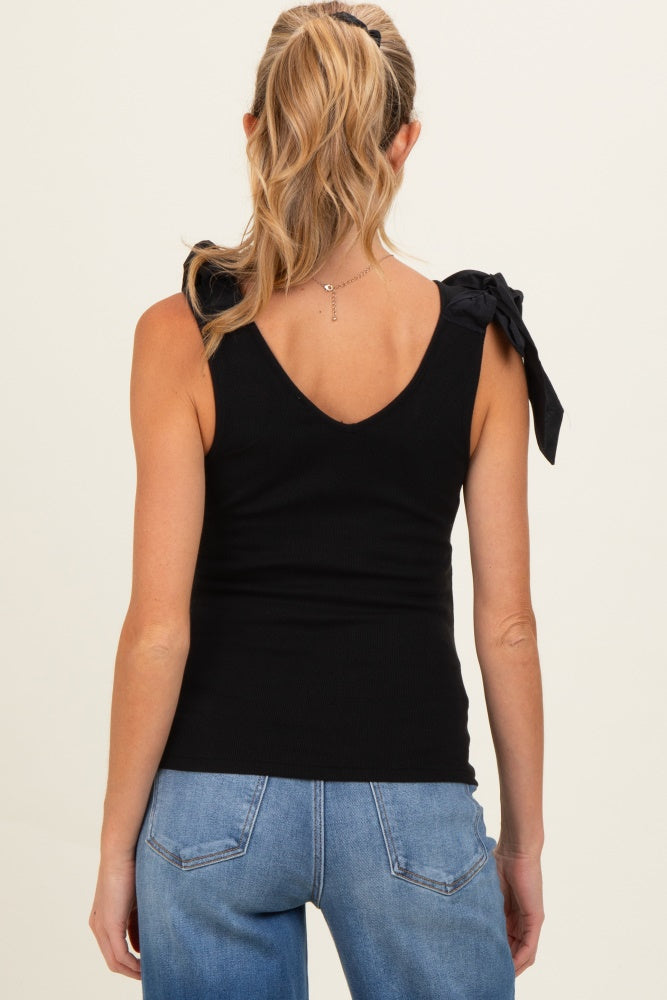 woman wearing a black maternity top with tie detail on the shoulders and showing a relaxed fit from the back