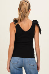 woman wearing a black maternity top with tie detail on the shoulders and showing a relaxed fit from the back