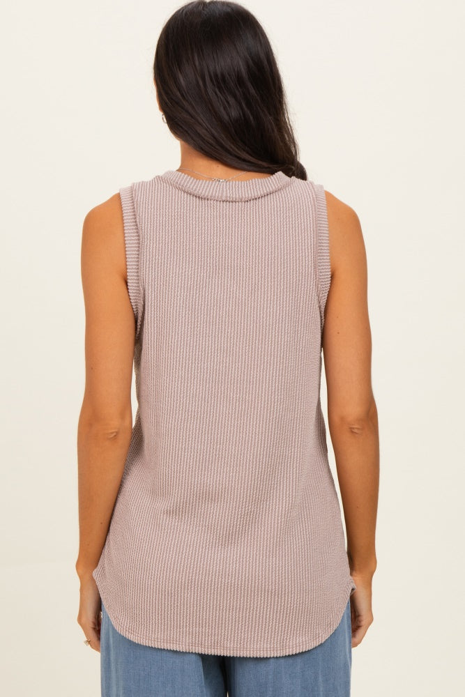 woman wearing a sleeveless light mauve ribbed top with a relaxed fit and curved hemline, viewed from the back