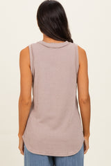 woman wearing a sleeveless light mauve ribbed top with a relaxed fit and curved hemline, viewed from the back