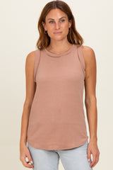 woman wearing a dusty rose ribbed sleeveless top with a round neckline and relaxed fit