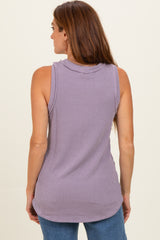 woman wearing a lavender sleeveless ribbed top with a high neckline and loose fit from the back