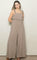 woman wearing a beige ruffled strap jumpsuit with a flowy silhouette and wide legs