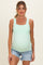 woman wearing a mint green maternity tank top and showing her baby bump with distressed denim shorts