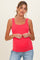 woman wearing a bright pink maternity tank top and showing her baby bump