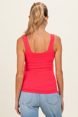 woman wearing a bright pink maternity tank top, showing a fitted style and a smooth back design