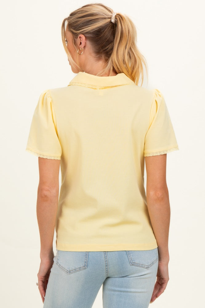 woman wearing a yellow short sleeve maternity top with lace trim, view from the back