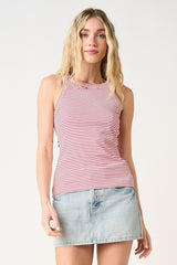 woman wearing a red and white striped sleeveless tank top with a high neckline and a denim mini skirt