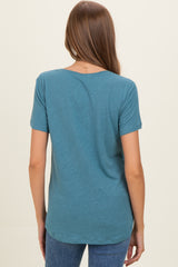 woman wearing a teal short sleeve maternity top, seen from the back, with a relaxed fit and rounded hem