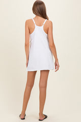 woman wearing a white maternity tank dress with a relaxed fit, showing her back and the dress length above the knee