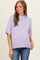 woman wearing a light purple short sleeve maternity sweater with a ribbed hem and a visible baby bump