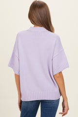 woman wearing a lilac oversized maternity sweater with short sleeves and a ribbed hem