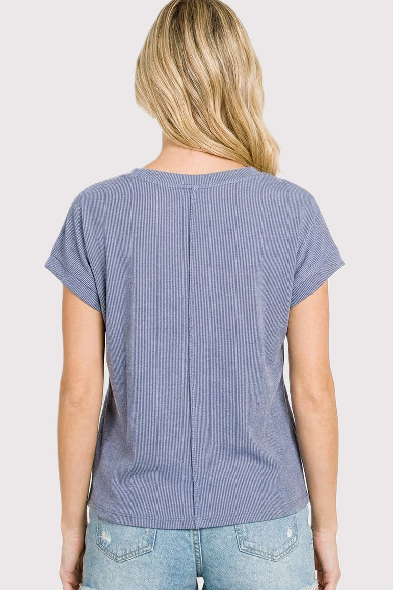 woman wearing a blue striped short sleeve top with a relaxed fit and back seam detail, seen from the back